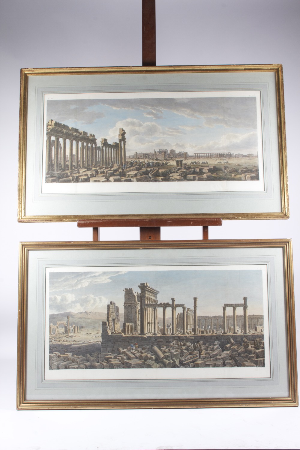 A pair of coloured French engravings depicting Greek ruins, 44 x 94 cm.