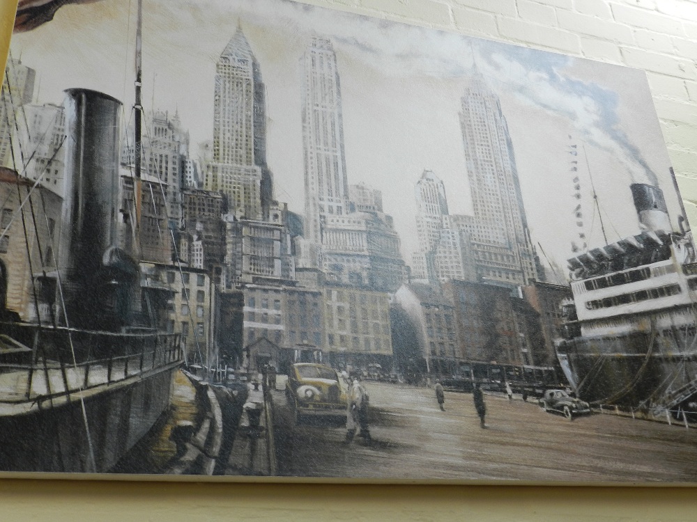 A large unframed canvas depicting a city skyline.