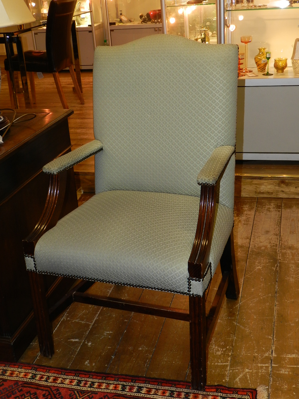 A pair of mahogany framed Gainsborough style elbow chairs upholstered in diamond stitch green fabric