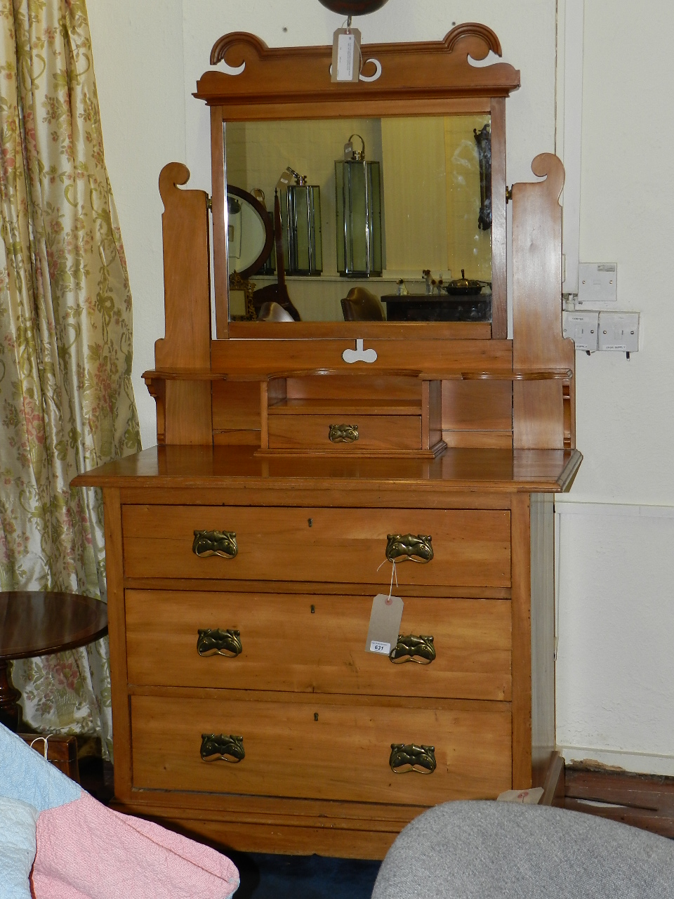 An art nouveau walnut mirror back dressing chest of three long drawers raised on a shaped apron.