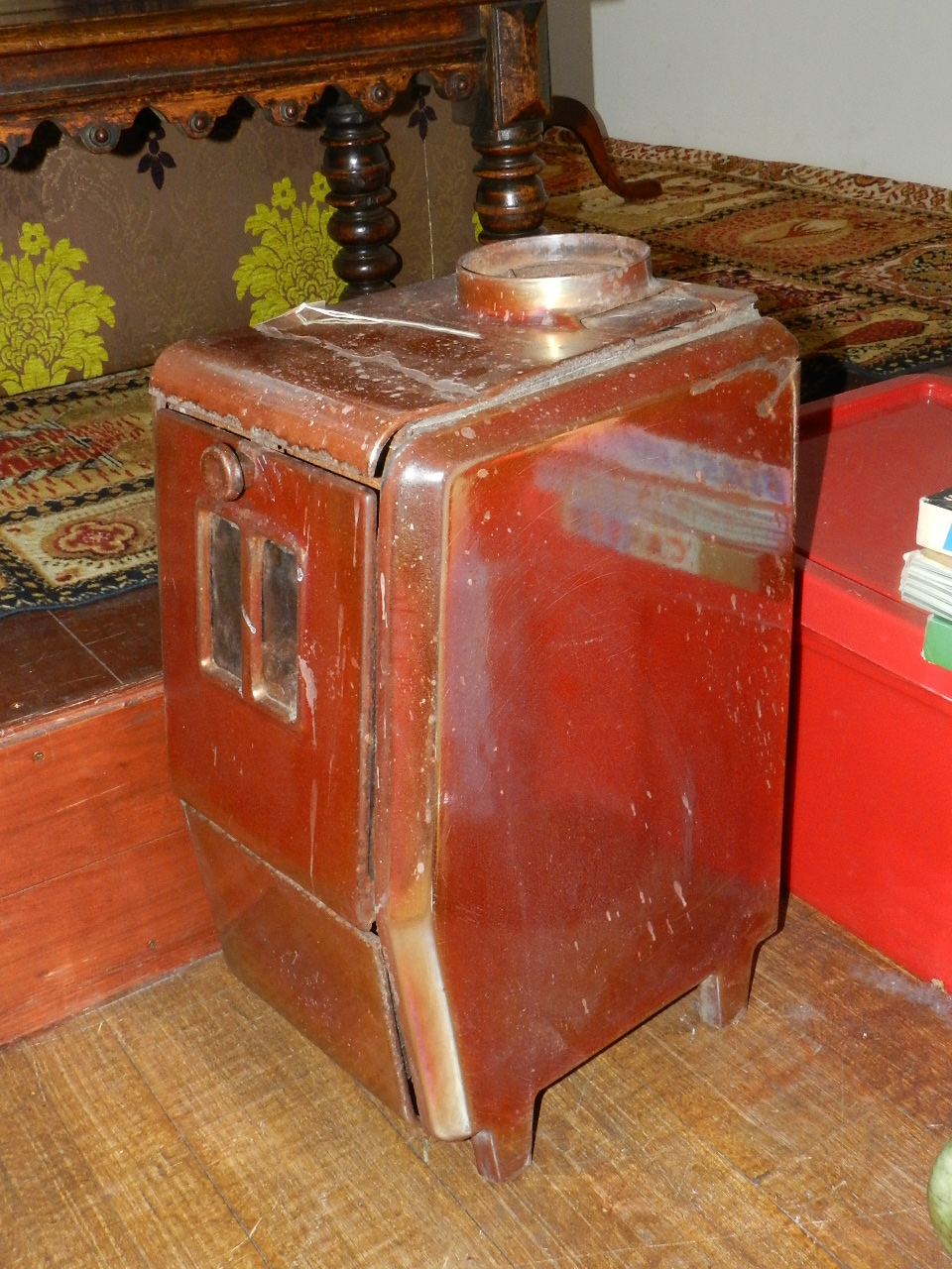 A cast iron solid fuel burner in a metallic copper enamel.