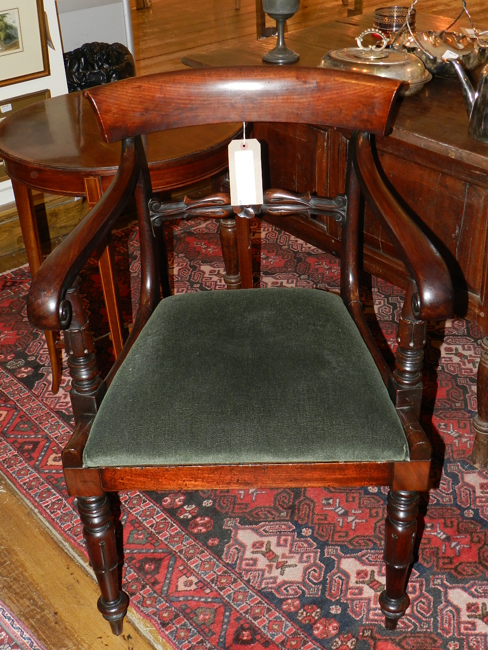 A William IV carved mahogany bar back open elbow chair having drop in seat raised on tulip supports
