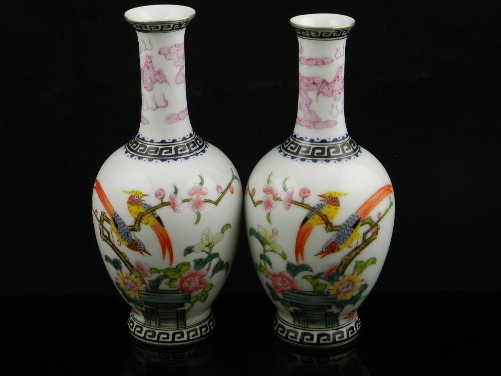 A pair of Chinese ovoid vases decorated with exotic birds, flowers and foliage.