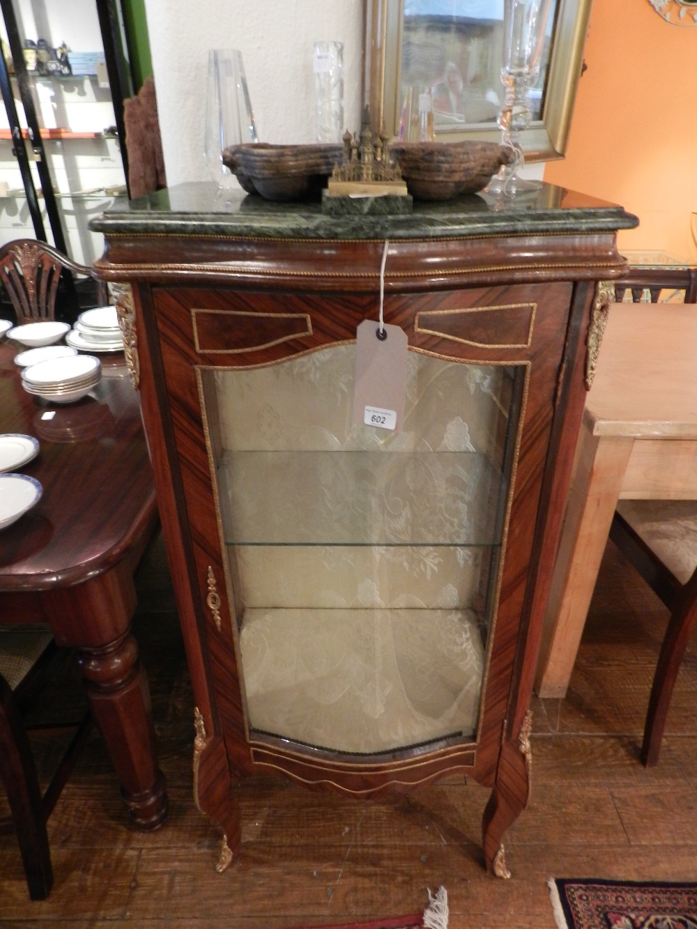 A French marble topped ormolu mounted King wood Vitrine having serpentine glazed door enclosing