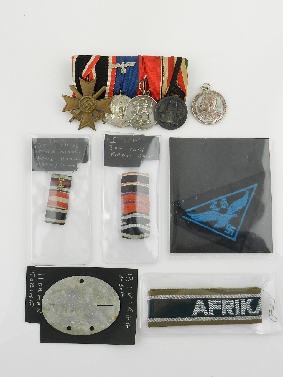 A collection of German WW2 militaria, to include; a group of four medals, war merit cross with