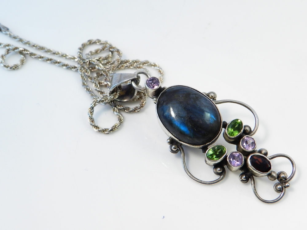 A sterling silver chain and pendant, mounted with oval labourite, amethyst pendants and garnet.