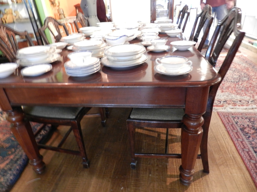 A Victorian mahogany extending dining table having two extra leaves