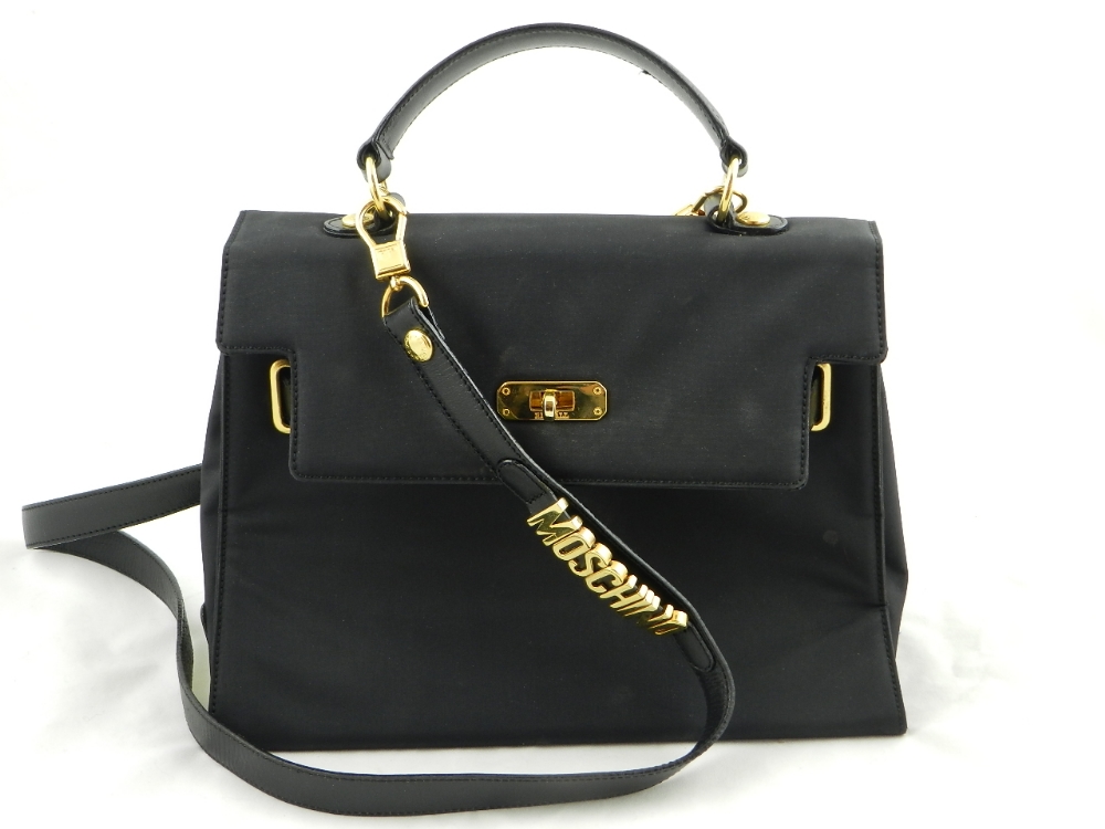 A stylish black Moschino canvas handbag with strap.