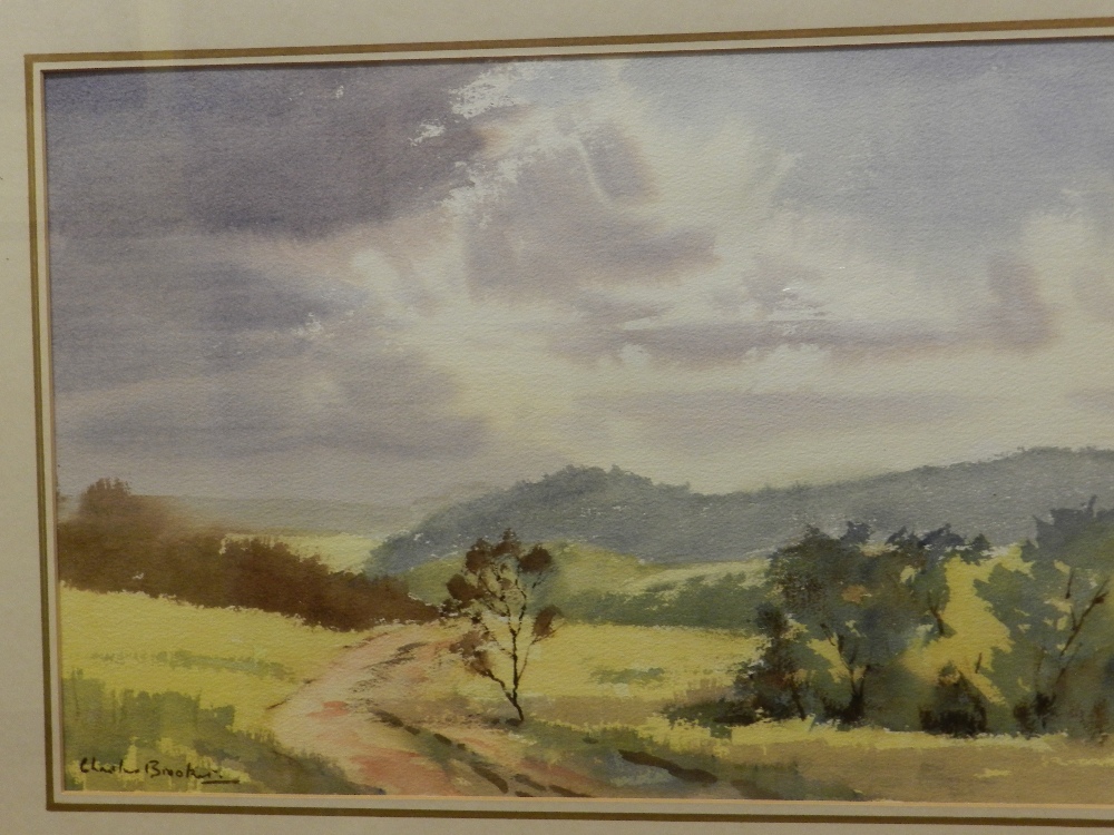 A gilt framed watercolour depicting a country side scene signed Charles Brooker.