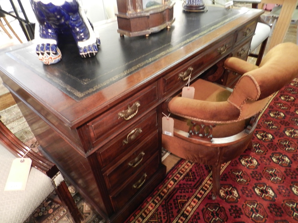 A late Victorian mahogany pedestal desk having gilt tooled leather insert above an arrangement of
