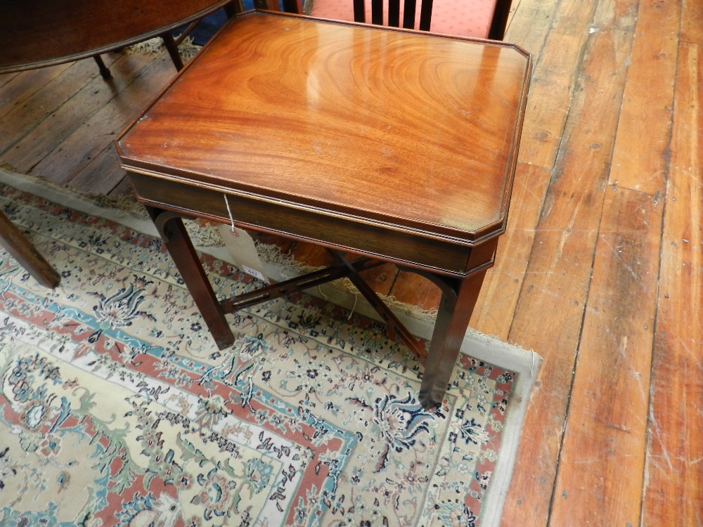 A Georgian style mahogany low table of single drawer raised on chamfered square section supports