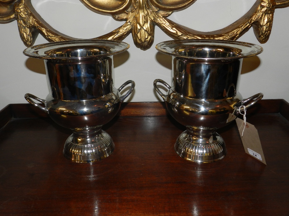 A pair of silver plated twin handled campana form ice buckets