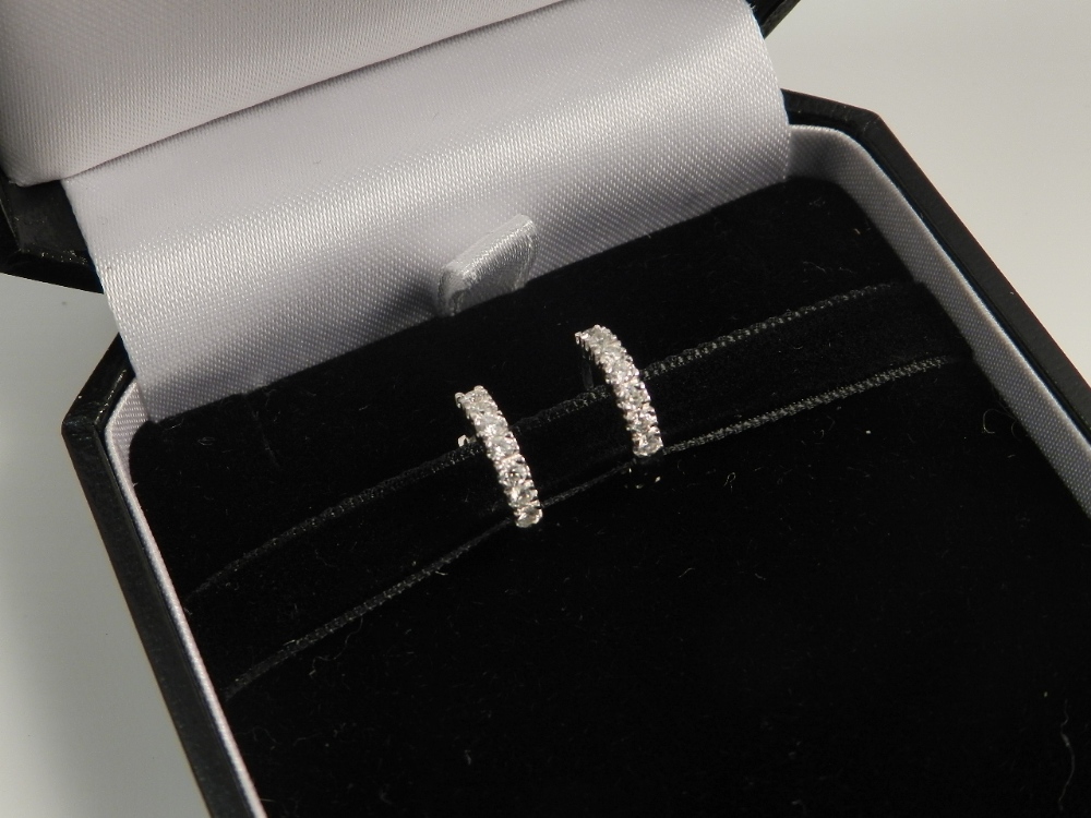 A pair of diamond mounted 18ct white gold earrings of hoop design