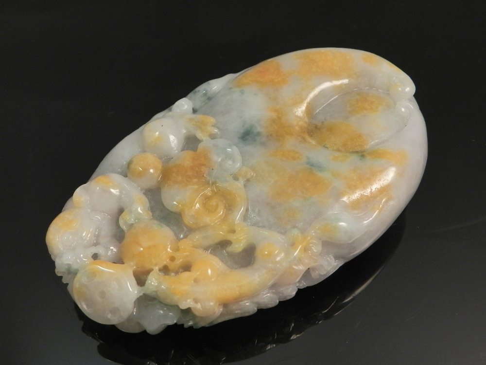 A Chinese carved jade paperweight decorated with dragons.