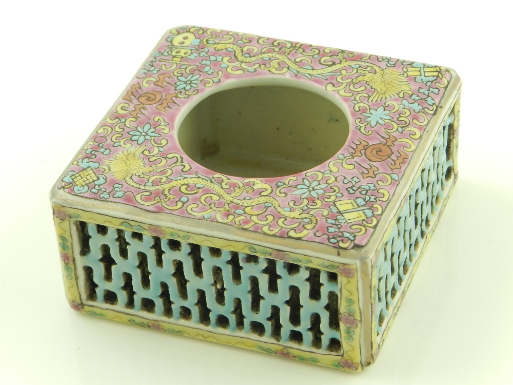 A Chinese porcelain double walled inkwell enamel decorated with dragon designs having pierced sides