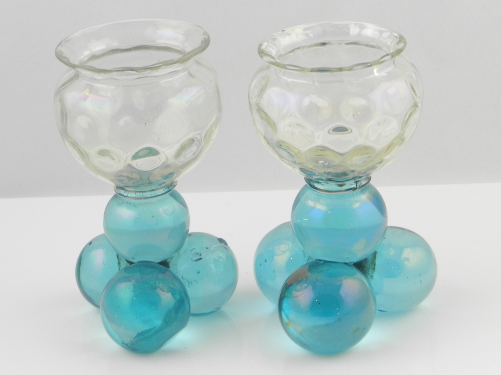 A pair of continental glass vases, the dimpled bowls on four globular turquoise bases.