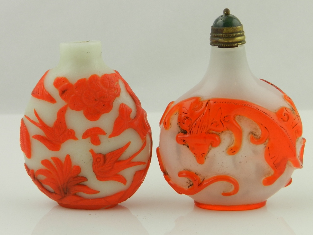 Two Chinese Peking glass snuff bottles one with stopper