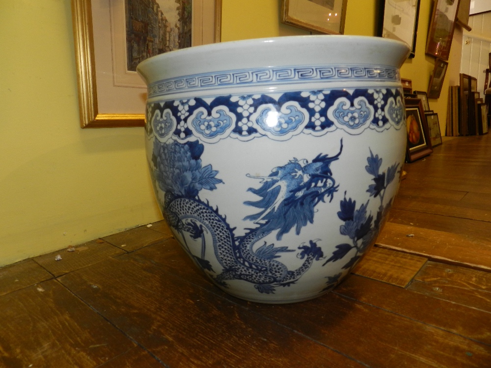 A large Chinese blue and white porcelain jardiniere decorated with twin four clawed dragons