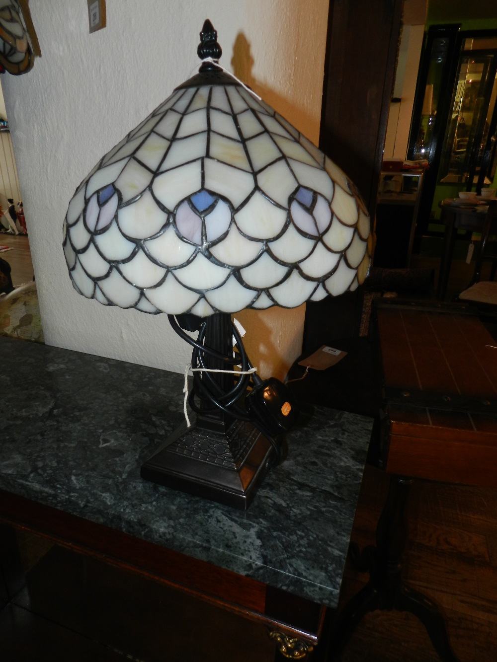 A Tiffany style lamp base with leaded glass shade of peacock feather design
