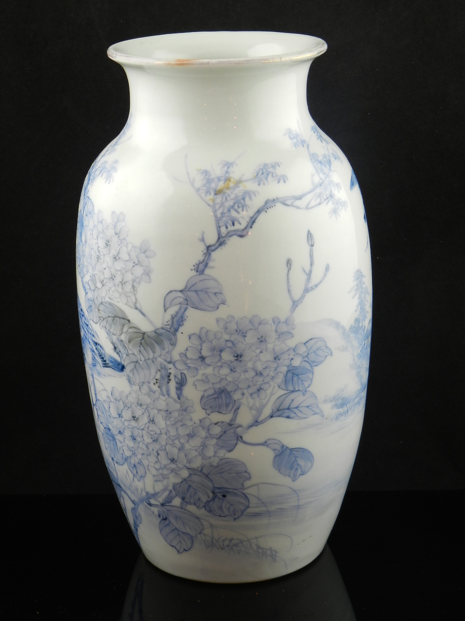 A Chinese blue and white vase decorated with birds in a naturalistic setting