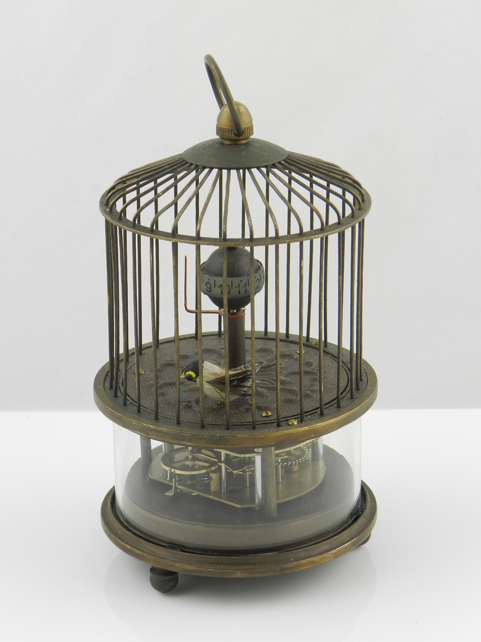 A gilt metal novelty clock of bird cage form.