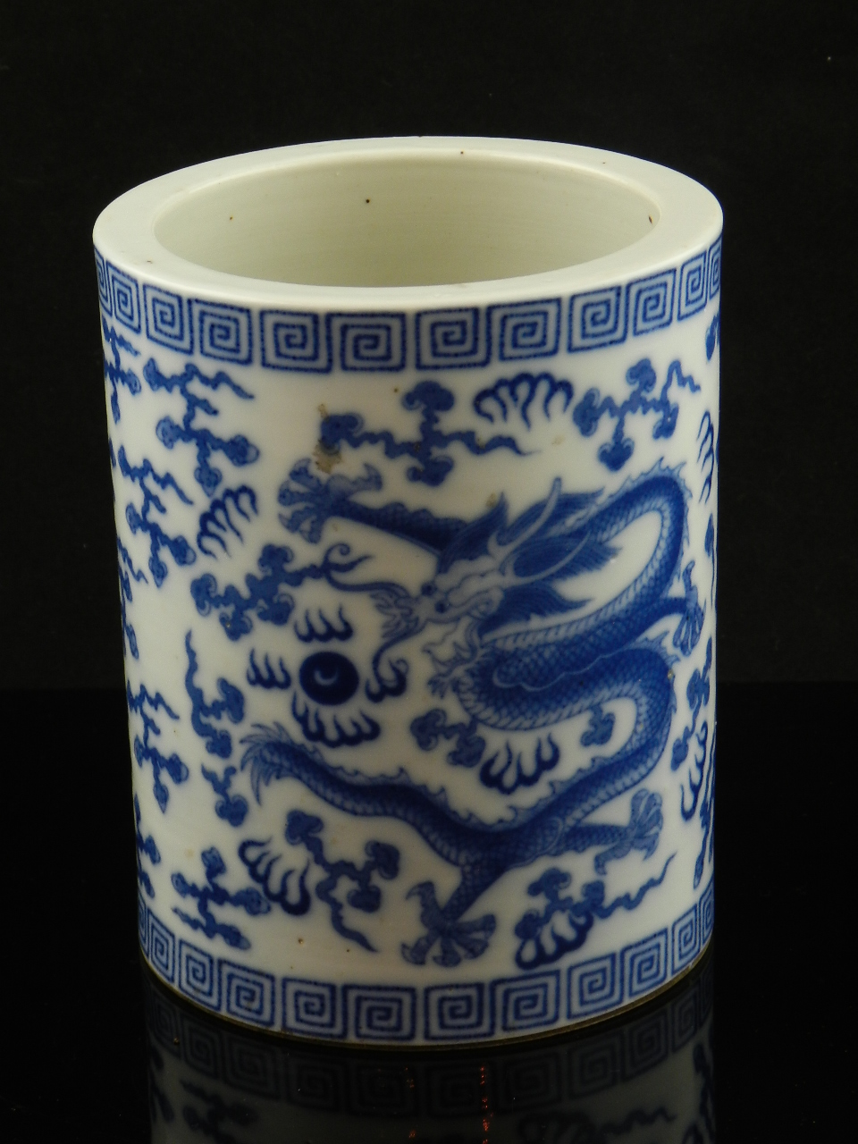 A Chinese blue and white porcelain bowl decorated with character marks and floral banding.