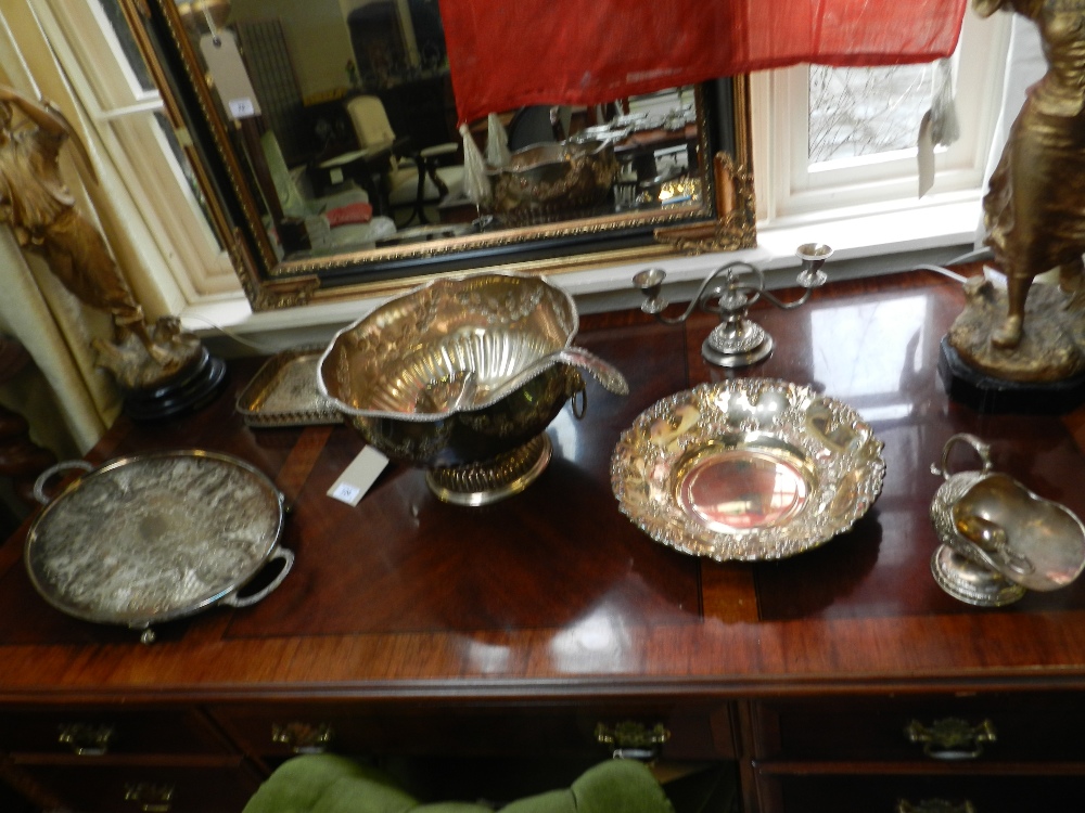 A quantity of silver plated items to include twin handled punch bowl, candlesticks, serving tray