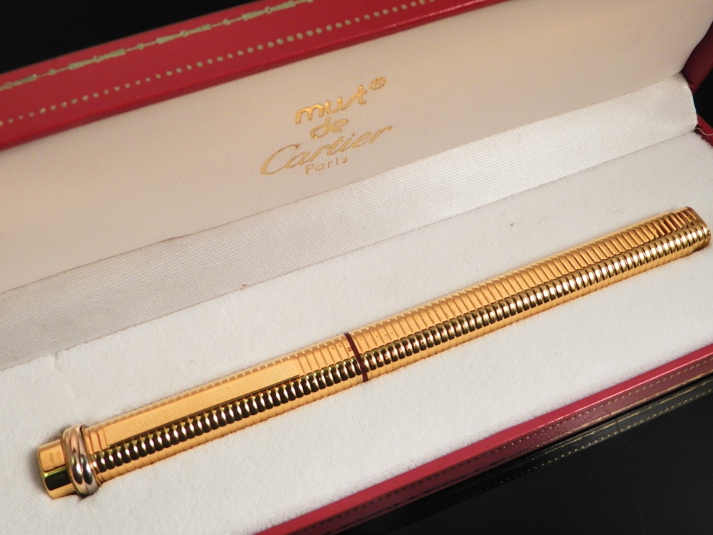 A 1970s `Must` Cartier gold plated ball point pen in original box.