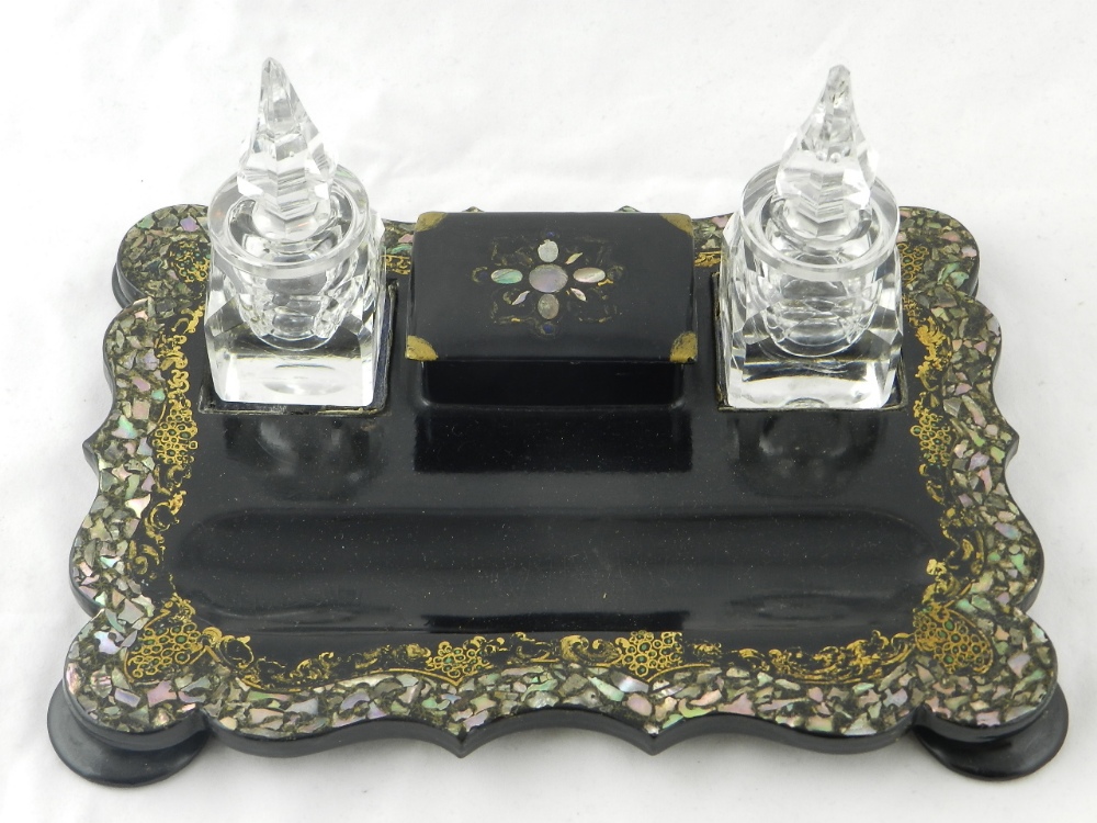 A Victorian mother of pearl inlaid ink stand having two cut glass inkwells.