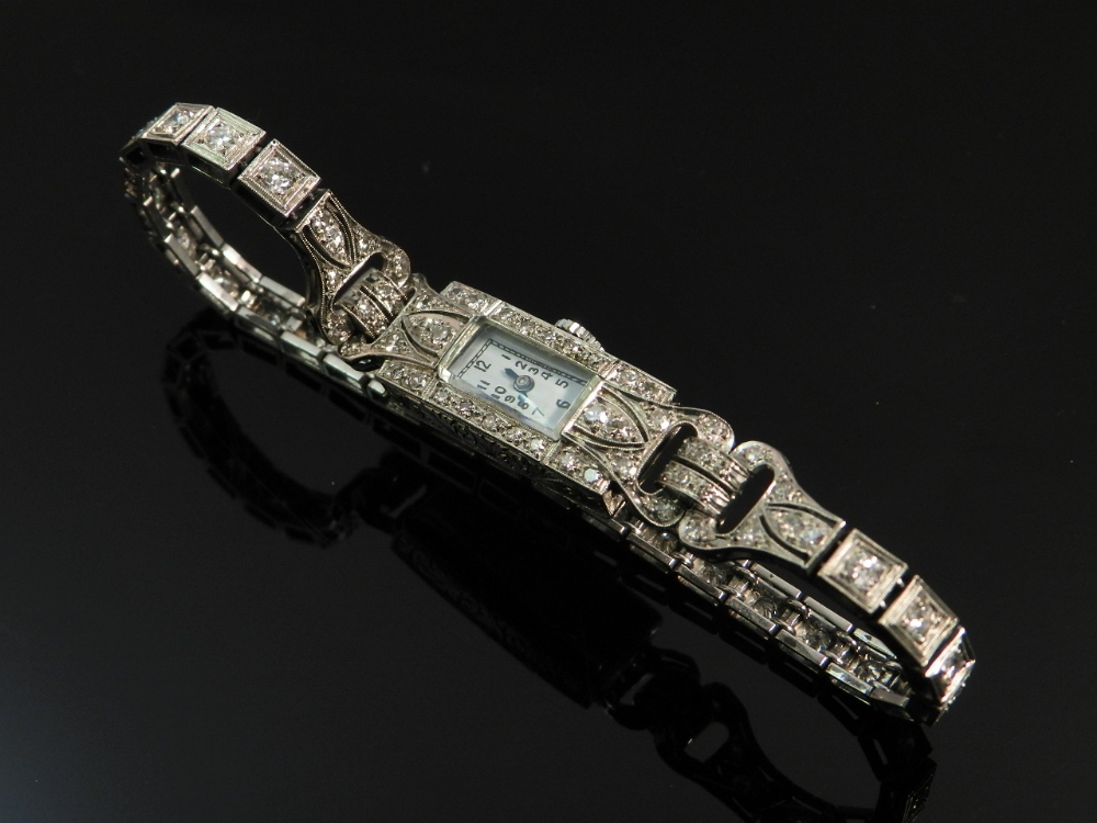 An art deco diamond mounted platinum lady`s cocktail watch.