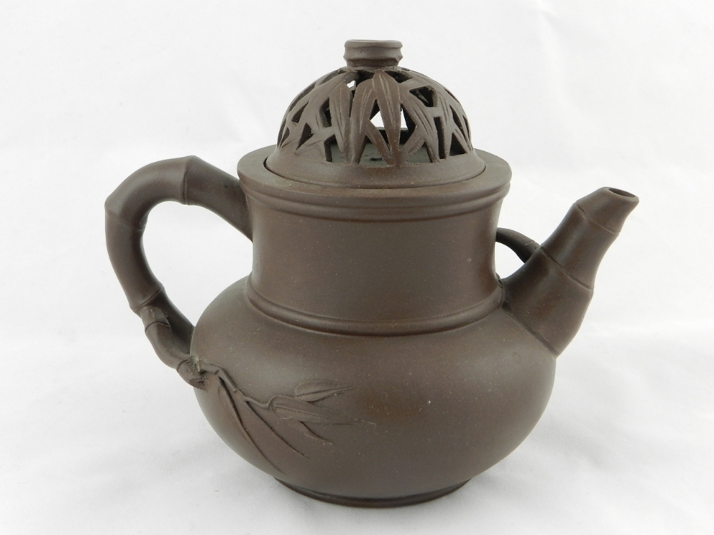 An antique Chinese unusual shaped Yi Xing teapot with a filigree pierced lid decorated with leaves