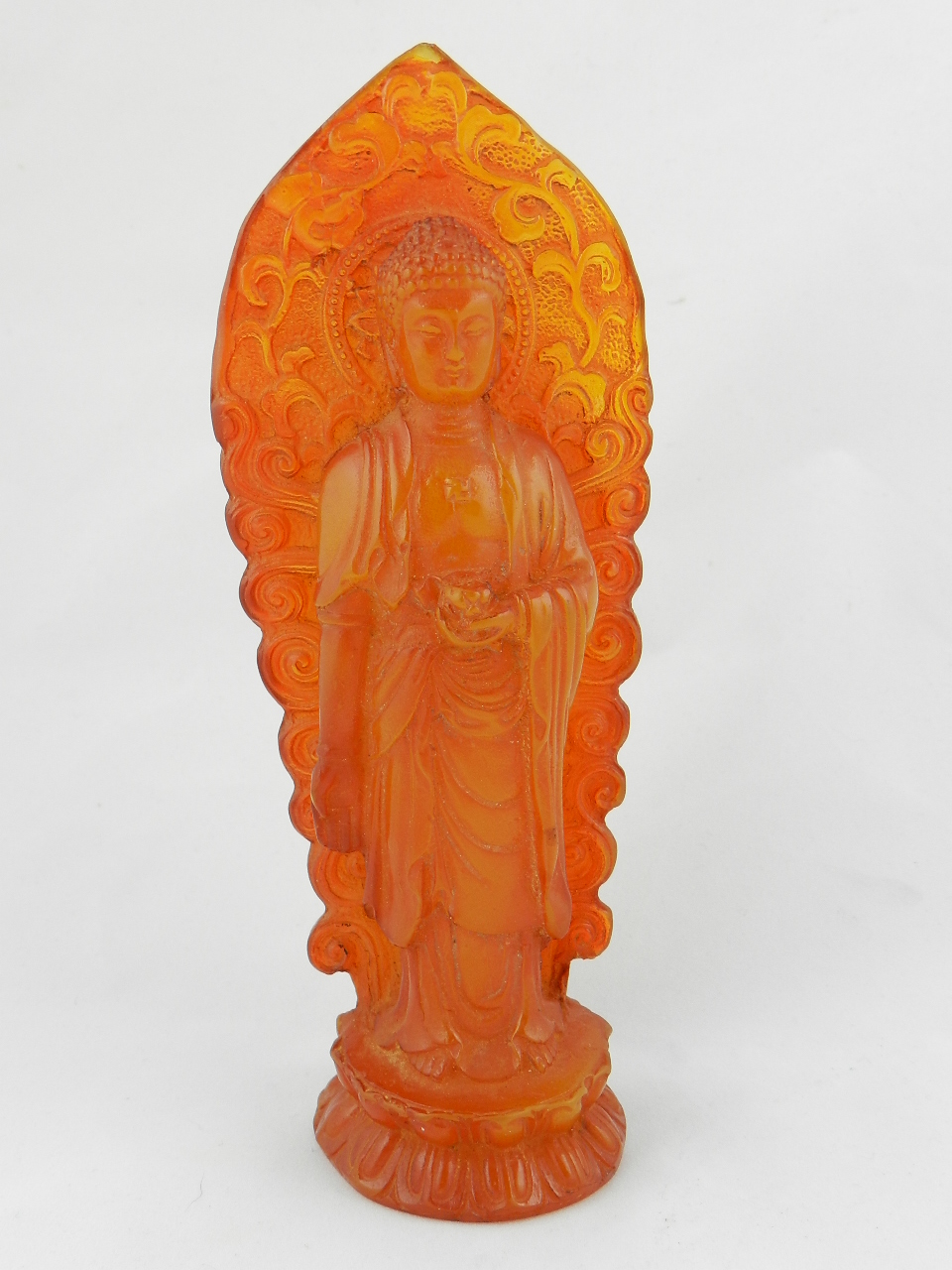 A reconstituted amber model of a standing Buddah