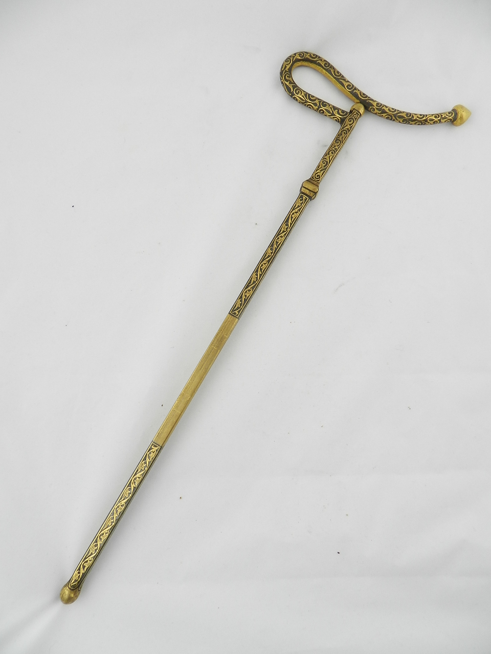 A Mutteka dervish neck rest with detachable blade decorated with gold inlay work.