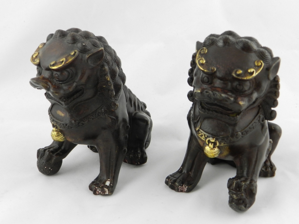 A pair of Chinese cast bronze dogs of fo with gilt highlights