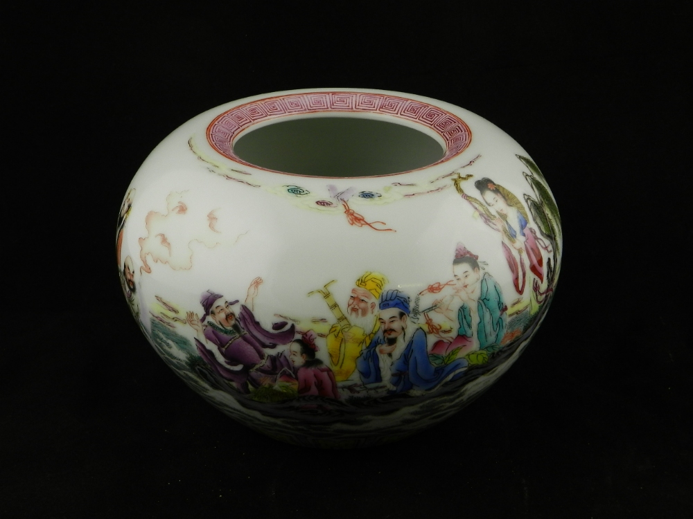 A Chinese porcelain bowl with mythical decorations and blue underglazed characters and the base, 9cm