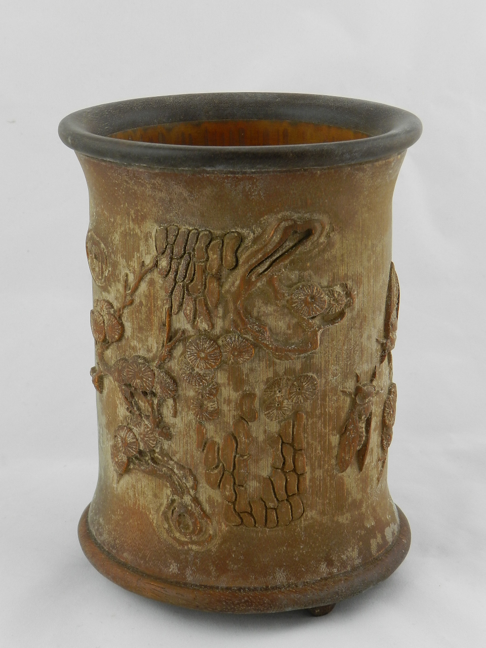 A Chinese bamboo brush pot carved with insects and prunus blossom