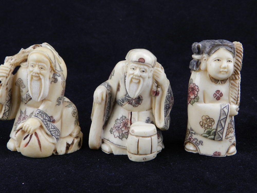 Three carved bone netsukes, two elderly scholars and one maiden