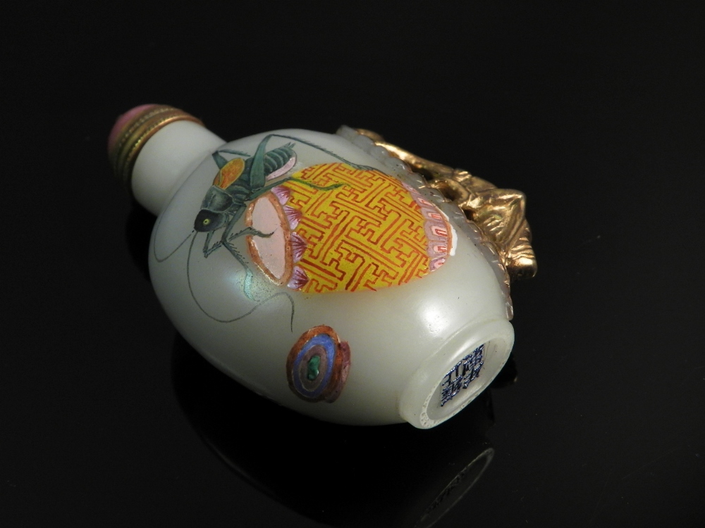 A Chinese snuff bottle with crickets painted to the sides and applied gilt cricket to the side