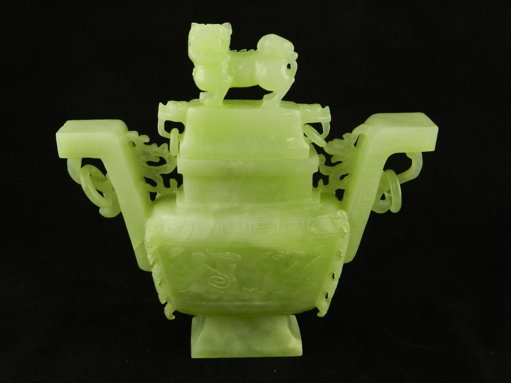 A Chinese green jade rectangular vase and cover, ring side handles, pull off cover with Dog finial