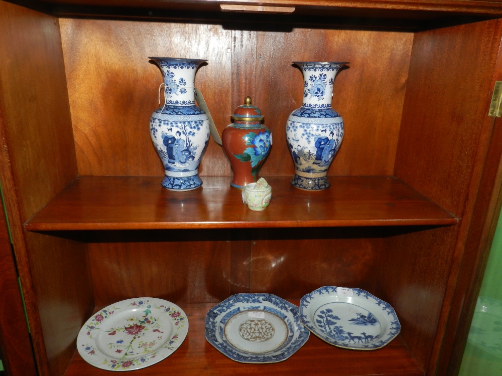 A collection of oriental porcelain items to include three plates, two ginger jars, a pair of blue