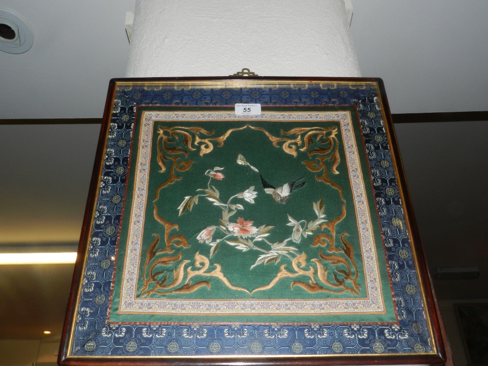 A 19th century Chinese framed silk panel woven with birds, flowers and leaves