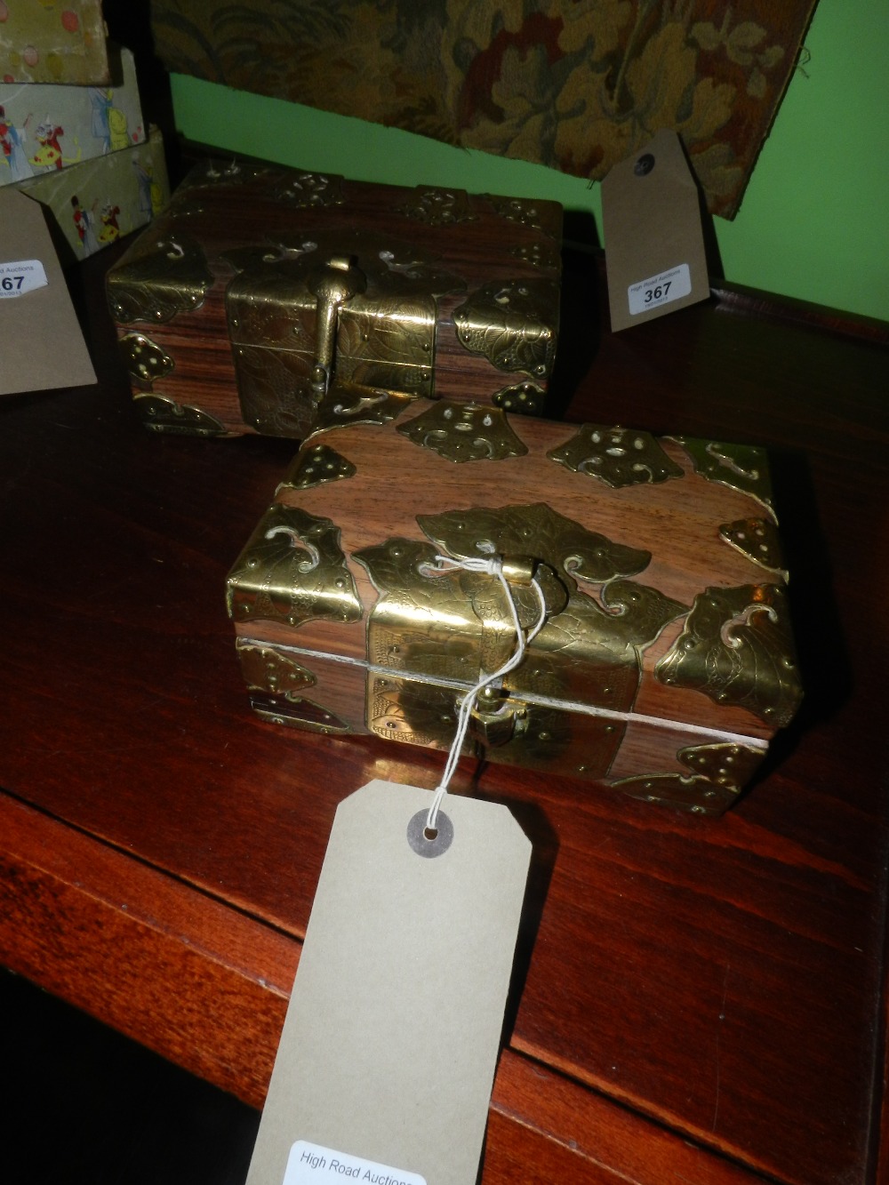 A pair of oriental hardwood caskets having brass clasp and mounted