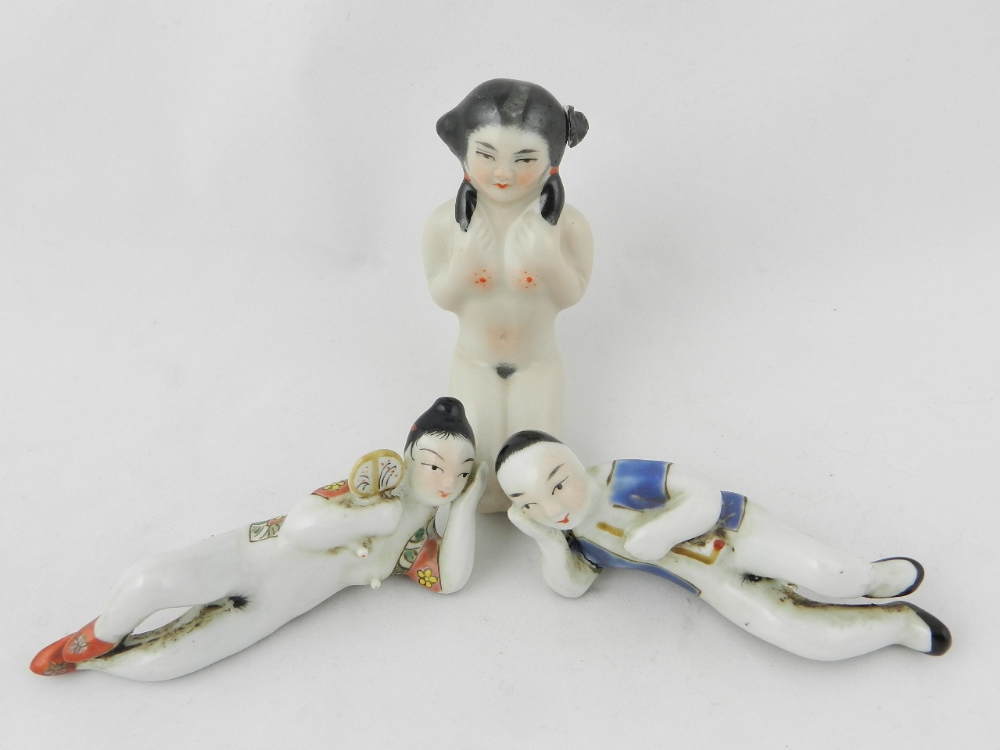 A pair of porcelain erotic nudes along with a snuff/scent bottle fashioned as a nude maid.