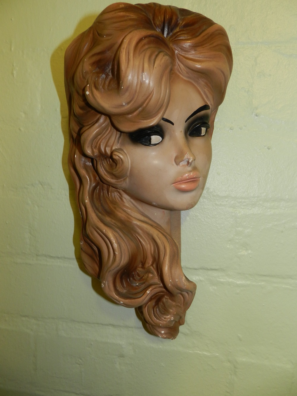A 1950s plaster wall mask of Brigitte Bardot.