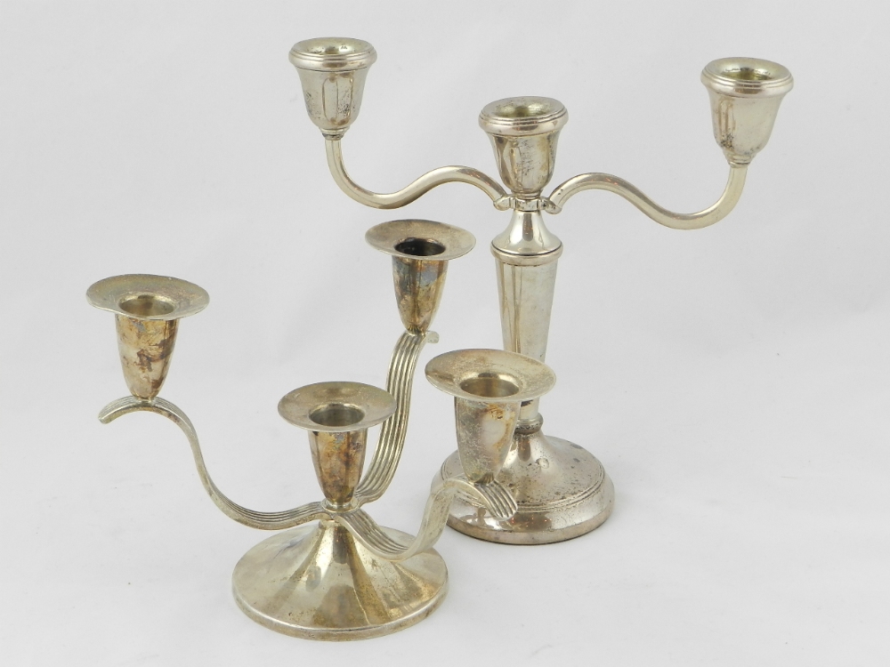 A silver dwarf three branch candelabrum and a silver three branch candelabrum