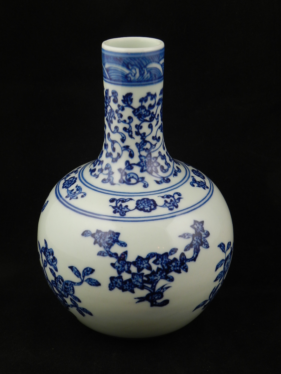 A Chinese blue and white porcelain bottle vase decorated with flowering sprigs.