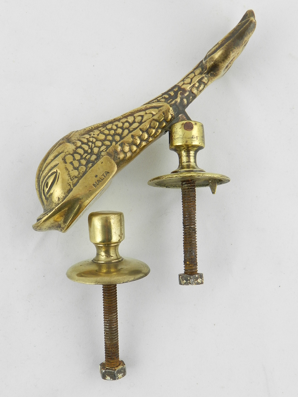 An antique brass door knocker in the form of a dolphin stamp Malta