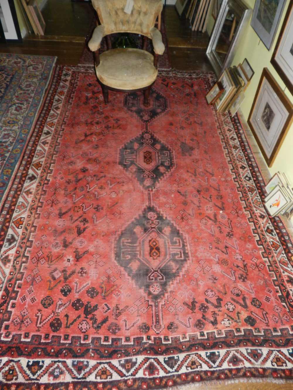 A tribal rug decorated with floral panels together with one other having triple pole medallion on