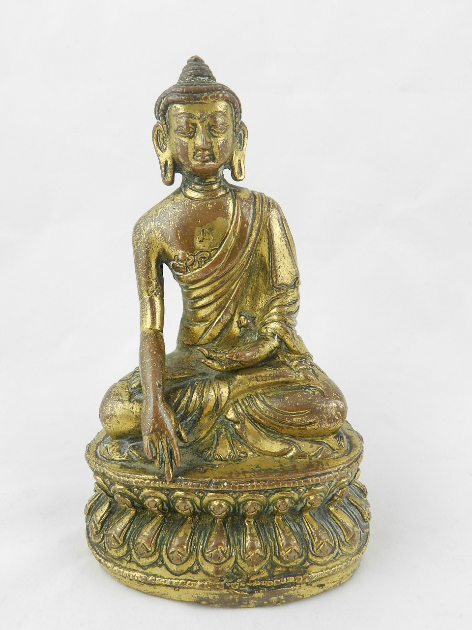 An oriental gilt metal figure of a seated Buddha.