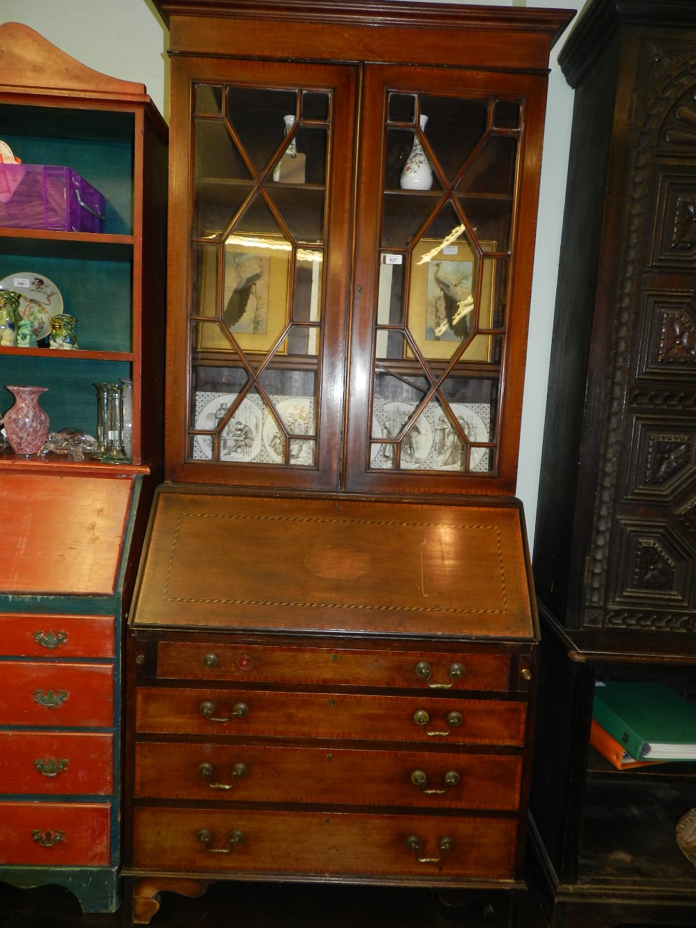 An Edwardian inlaid mahogany bureau bookcase having two astral glazed down above fall front and four